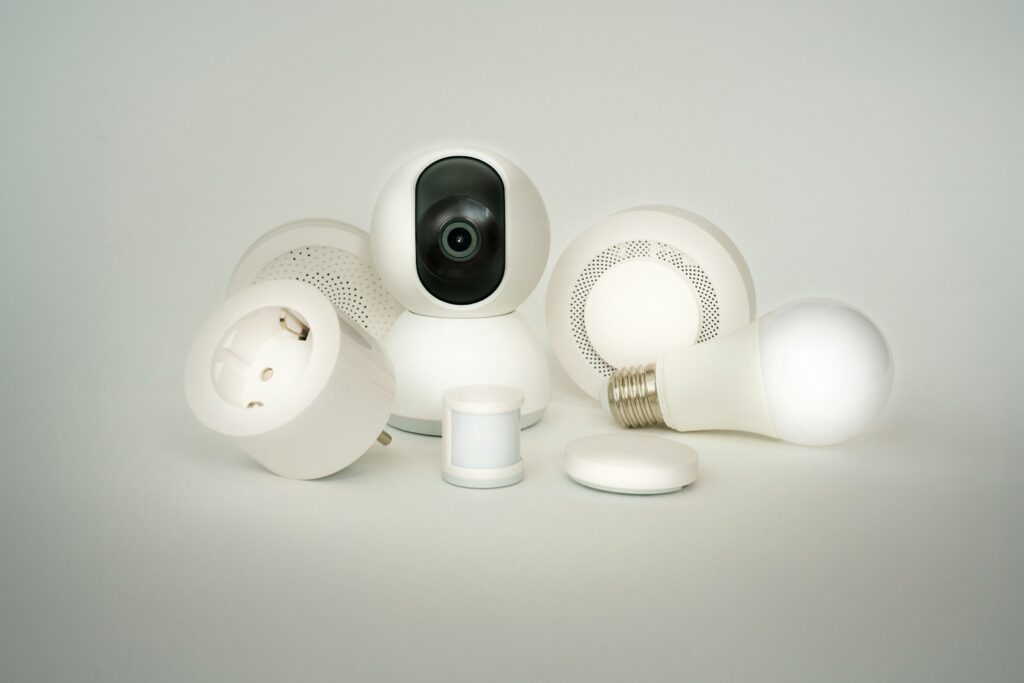 A camera sitting on top of a pile of white objects. Smart home devices.