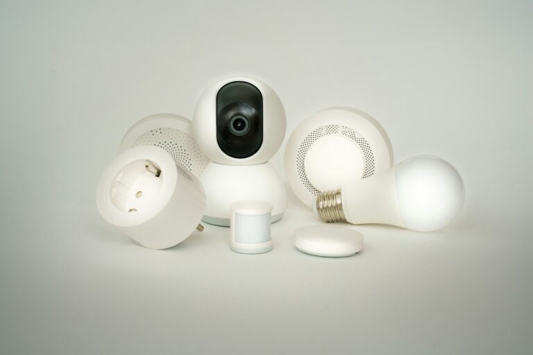 A camera sitting on top of a pile of white objects. Smart home devices.
